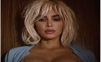 Kim Kardashian Sings ‘Santa Baby’ in Surreal Party Video Featuring a Very Unlikely Santa